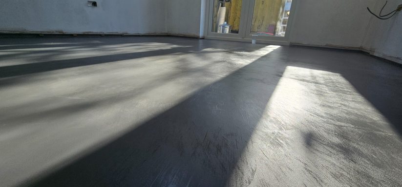 Dark grey microcement floor installed in a modern Norfolk home
