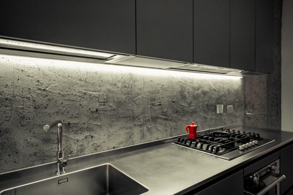Smooth microcement countertop with textured splashback in Norfolk kitchen